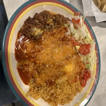La Zenita - Tamale Platter. "Christmas" sauce - A Mexican dish featuring rice, a cheese-covered enchilada with sauce, a side salad with lettuce and tomatoes, and a beef tamale on a decorative plate. - Mexican Near Me - Albuquerque, New Mexico
