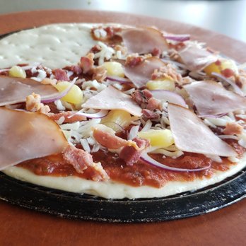 Top That Pizza - a pizza on a wooden board - Pizza Near Me - Tulsa, Oklahoma Top That Pizza - a pizza on a wooden board - Pizza Near Me - Tulsa, Oklahoma