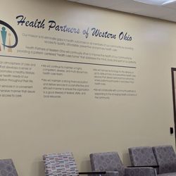 Old West End Community Health Center - Wall claiming they give great care. I don't see it!