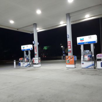 Chevron - gas pumps at a gas station at night - Gas Stations Near Me - West Sacramento, California