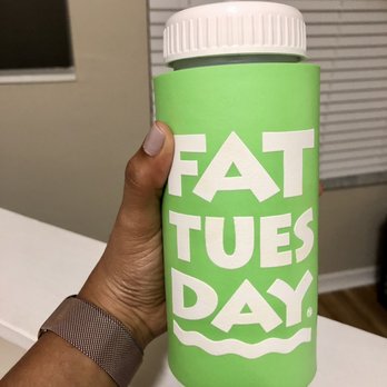 Fat Tuesday At Celebration Pointe Gainesville - a hand holding a fat tuesday water bottle - Cocktail Bars Near Me - Gainesville, Florida Fat Tuesday At Celebration Pointe Gainesville - a hand holding a fat tuesday water bottle - Cocktail Bars Near Me - Gainesville, Florida