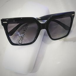 Calvin Klein prescription sunglasses and case.