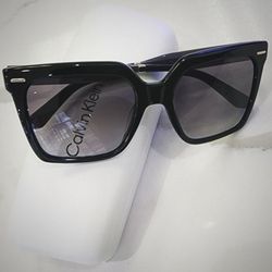 See Clear Optometry - Calvin Klein prescription sunglasses and case.