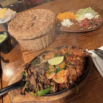Chuy's Fiestas - Fiesta Fajitas. Massive portion (feeds 2!) for $21.50. Warm, homemade tortillas inside the basket. The dish in the back is also included. - Mexican Near Me - San Francisco, California