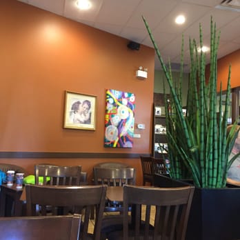 Second Cup - a woman standing in a restaurant - Coffee & Tea Near Me - Edmonton, Alberta