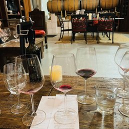 a table with wine glasses and a menu a table with wine glasses and a menu