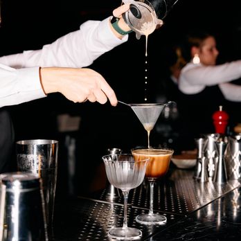 The Lobby Bar - a bartender pouring a martini - Piano Bars Near Me - Phoenix, Arizona The Lobby Bar - a bartender pouring a martini - Piano Bars Near Me - Phoenix, Arizona