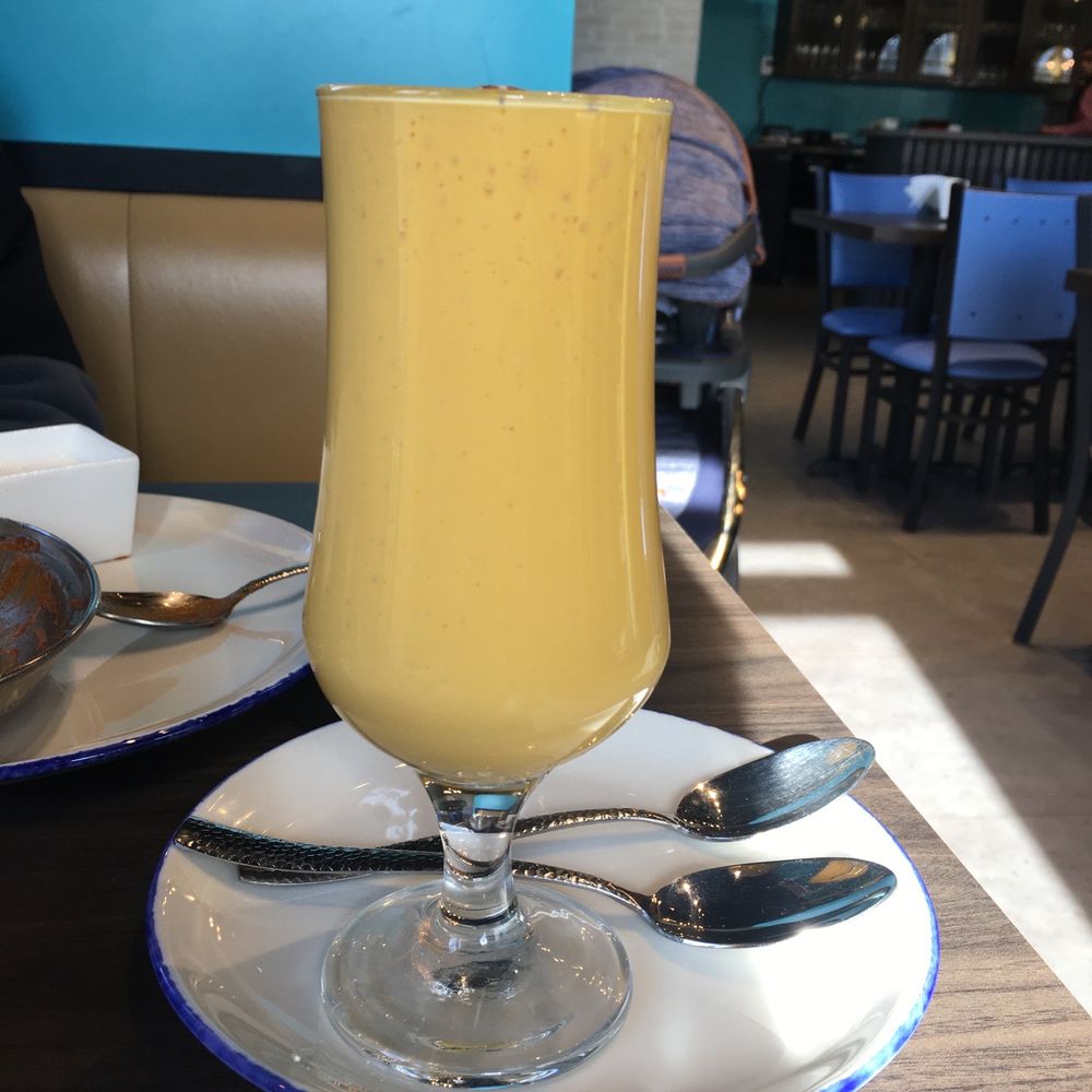Amritsari Dhaba - a glass of orange juice on a plate - Indian Near Me - Brampton, Ontario Amritsari Dhaba - a glass of orange juice on a plate - Indian Near Me - Brampton, Ontario