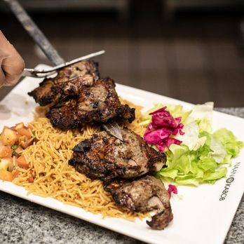 Naan and Kabob - a person cutting a piece of meat - Halal Near Me - Scarborough, Ontario Naan and Kabob - a person cutting a piece of meat - Halal Near Me - Scarborough, Ontario