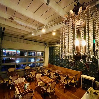 Chez Phinney - a dining room with a chandelier - Wine Bars Near Me - Seattle, Washington Chez Phinney - a dining room with a chandelier - Wine Bars Near Me - Seattle, Washington