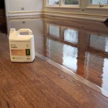 GC Floor Sanding - a hardwood floor with a gallon of gc - Flooring Near Me - Chicago, Illinois