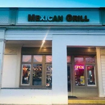 Mexican Grill - Exterior view of Mexican Grill restaurant with a neon 'OPEN' sign in the window, under a blue sky. - Mexican Near Me - Poolesville, Maryland