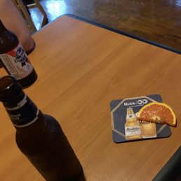 a half of a grapefruit and half of a beer on a table a half of a grapefruit and half of a beer on a table