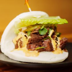 Steam Boys - Juicy chunks of beef shank, pickles, crisp lettuce, and a spicy mayo sauce, all embraced by a soft, sweet bao bun.