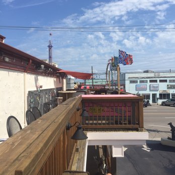 Olde Salty - a man sitting on the deck of a restaurant - Seafood Near Me - Carolina Beach, North Carolina Olde Salty - a man sitting on the deck of a restaurant - Seafood Near Me - Carolina Beach, North Carolina