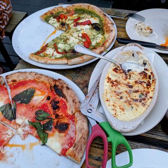Cornuto Pizzeria - buffalo moz and pesto pizzas with the gnocchi in gorgonzola sauce. so good! - Italian Near Me - Seattle, Washington