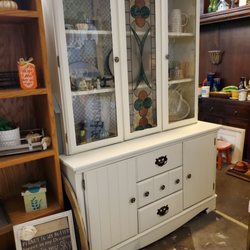 J & L Flea Market - China cabinets. This one has a stained glass center door.