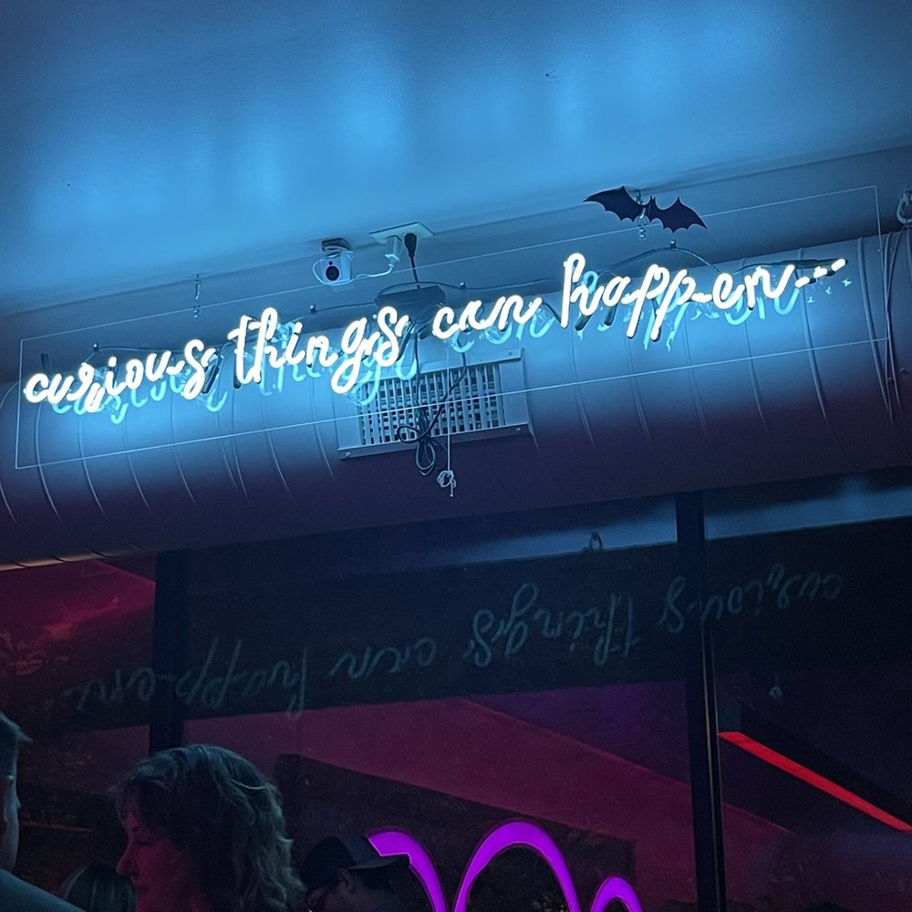 Plain Spoke Cocktail Company - a neon sign that says everything things can happen - Cocktail Bars Near Me - Madison, Wisconsin