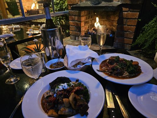 Photo of Il Terrazzo Ristorante - Victoria, BC, CA. Oso Buco on the right, and GAMBO di AGNELLO in front.