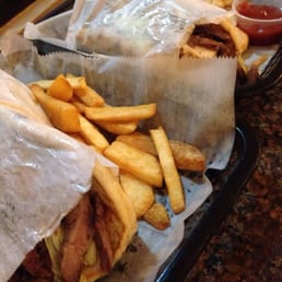 Churrasco-Doner mix sandwich in foreground, Chicken-Doner duo in background.