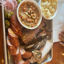 Three meat plate with sliced brisket, turkey breast, waygu jalapeño sausage with basic Mac and cheese and borracho beans. Three meat plate with sliced brisket, turkey breast, waygu jalapeño sausage with basic Mac and cheese and borracho beans.