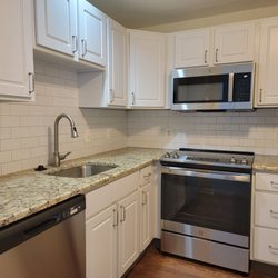 B Strong Interiors - Shaker cabinets, stone countertop, tile backsplash, vinyl flooring