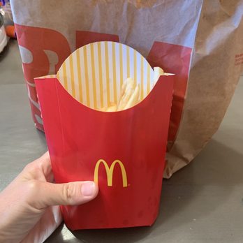 McDonald's - a hand holding a bag of fries - Fast Food Near Me - Mesa, Arizona