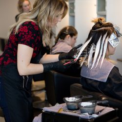 Elixir Hair Studio - Allana using the balayage technique to lighten her client.