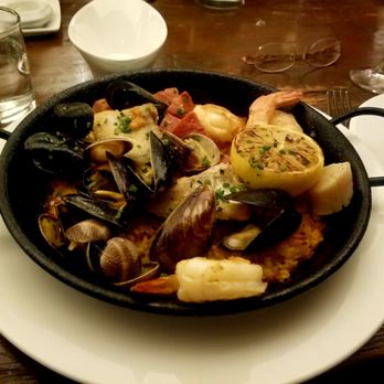 El Dorado Kitchen - Paella with salmon with crispy skin, chicken, sausage, shrimp, scallops, mussels, and clams, and super flavorful saffron rice - New American Near Me - Sonoma, California