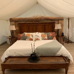 Whispering Springs - Meadowlark. Washroom facilities at the back of tent behind bed. View from bed to the outside, front part of tent.