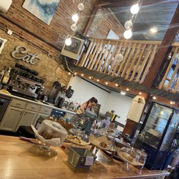 a coffee shop with a counter full of pastries