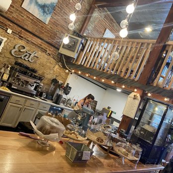 Coffee On the River - a coffee shop with a counter full of pastries - Coffee & Tea Near Me - Lansing, Iowa