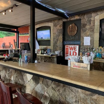 Tega Cay Tavern - a bar with a stone counter and bar stools - Barbeque Near Me - Tega Cay, South Carolina Tega Cay Tavern - a bar with a stone counter and bar stools - Barbeque Near Me - Tega Cay, South Carolina