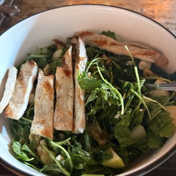 Ringolevio - A salad bowl contains grilled chicken slices on top of mixed greens, including arugula and other leafy vegetables. - Mediterranean Near Me - Brooklyn, New York