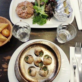 Le Petit Cler - Our lunch: Steak tartare with green salad and baked potato (top) and 6 escargot (bottom). - Bistros Near Me - Paris, 75