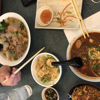 Vinh-Long - a table with bowls of food and chopsticks - Vietnamese Near Me - Nashville, Tennessee