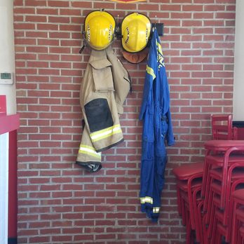 Firehouse Subs - a fireman's uniform hanging on a brick wall - Sandwiches Near Me - Jacksonville, North Carolina Firehouse Subs - a fireman's uniform hanging on a brick wall - Sandwiches Near Me - Jacksonville, North Carolina