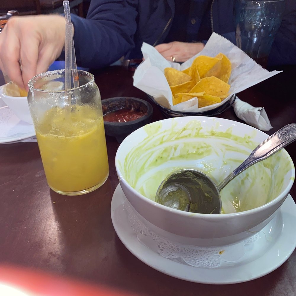 Empty bowl of Poblano Soup and a Passionfruit margarita