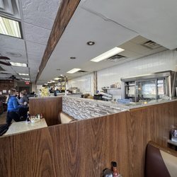 The Yolk Brunch House - That sign, in the far distance, is why they think they've covered themselves and that it's okay they charge extra for eggs.