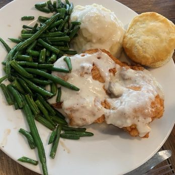 Emma's Southern Kitchen - My husband's chicken fried chicken smothered with cream gravy, green beans, mashed potatoes, and flaky biscuit. - Tacos Near Me - Knoxville, Tennessee
