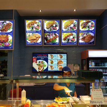 Le Greeka - a woman ordering food at a restaurant - Food Court Near Me - Toronto, Ontario Le Greeka - a woman ordering food at a restaurant - Food Court Near Me - Toronto, Ontario