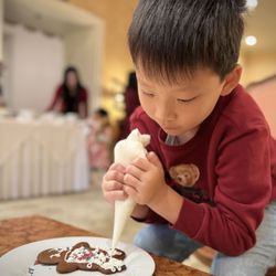 The California Club - Decorating gingerbread cookie at Children's Christmas Luncheon