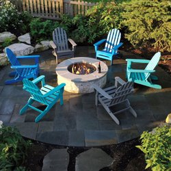Nature's Perspective Landscaping - Gabouri limestone-clad gas fire pit in an Ashlar pattern bluestone patio, with outcropping boulders that retain soil and offer more seating.