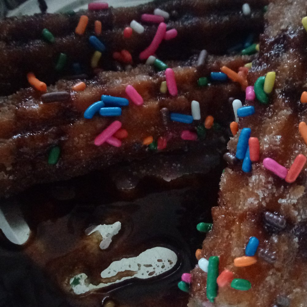 Grand Azteca V - Three churros covered in chocolate sauce and rainbow sprinkles. (Not pictured: the strawberry filling) - Mexican Near Me - Troy, Michigan Grand Azteca V - Three churros covered in chocolate sauce and rainbow sprinkles. (Not pictured: the strawberry filling) - Mexican Near Me - Troy, Michigan