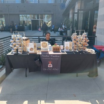 Smokin' Crackers Empanadas - man sitting at a table with a display of smokin'crackers - Specialty Food Near Me - Carson, California Smokin' Crackers Empanadas - man sitting at a table with a display of smokin'crackers - Specialty Food Near Me - Carson, California