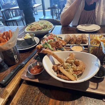 Finney's Crafthouse - Redlands - Mahi Tacos with side of onion rings, avocado egg rolls and BBQ salad, all delicious. - New American Near Me - Redlands, California