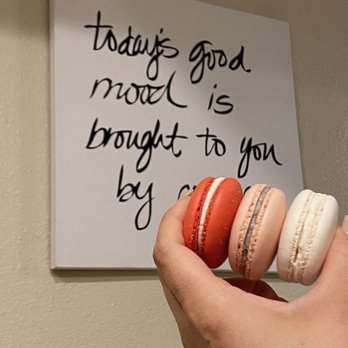 Demi's Treats - a hand holding three macarons - Macarons Near Me Demi's Treats - a hand holding three macarons - Macarons Near Me