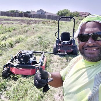 Skinners Lawn Care Management - a man standing in a field with a lawn mower - Lawn Services Near Me - Cedar Hill, Texas Skinners Lawn Care Management - a man standing in a field with a lawn mower - Lawn Services Near Me - Cedar Hill, Texas