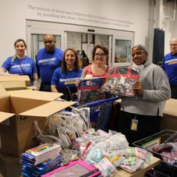 Shoes and Clothes For Kids - Volunteers from Progressive helping stock the shelves