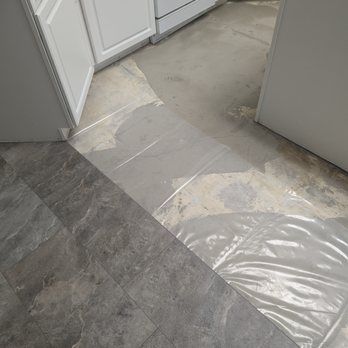 Floor Coverings International Jacksonville East - tile is put over moisture barrier plastic which is over leveled concrete - Flooring Near Me - Jacksonville, Florida Floor Coverings International Jacksonville East - tile is put over moisture barrier plastic which is over leveled concrete - Flooring Near Me - Jacksonville, Florida